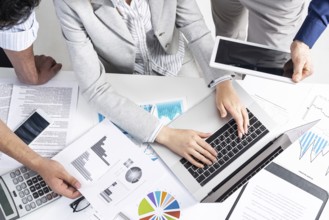 Corporate teamwork concept with businessmen. Secretary working with laptop Office desk with
