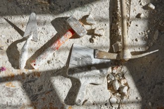 Mason tools on debris background in house improvement construction