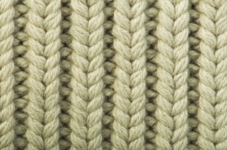 Old knit sweater background. Beige color. Studio shot