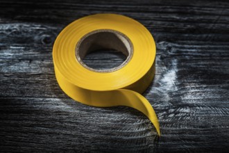 Yellow electrical tape on vintage wooden board