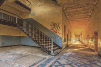 A long, deserted corridor with stairs and graffiti on the walls, Prison H11, Lost Place, Verviers,