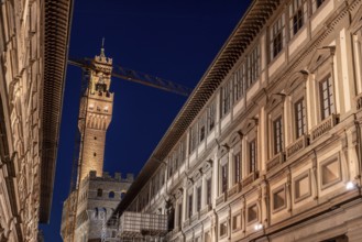 The famous Uffizi and the tower of the Palazzo Vecchio of Florence illuminated at night, Italy,
