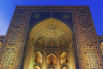 Tilya-Kori Madrasah with lights on Registan square