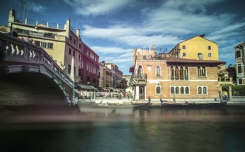 Ancient buildings and boats in the channel in Venice