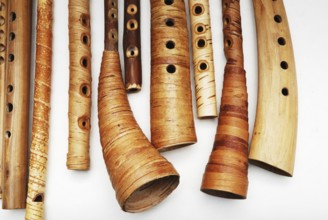 Ancient woodwind folk instruments on a white