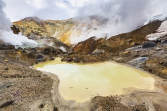 Lake in crater of active volcano. Beautiful dramatic volcanic landscape: hot spring, fumarole,