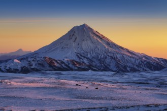Stunning winter mountain landscape of Kamchatka Peninsula, beautiful morning snow capped cone of