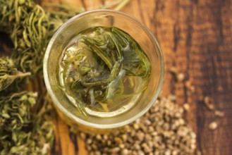 Cannabis herbal tea on wooden background
