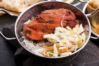 Close-up of a plate of chopped tandoori chicken