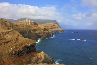 Eastern tip of the island of Madeira. Rocks steeply in the blue waters of the Atlantic Ocean. Over