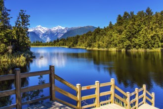 Magnificent snow-capped mountains and forests surround the Lake Matheson. Mirror glacial lake Lake