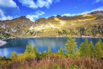 Glacial lake with clear cold water. The concept of ecological tourism. The harmony of the Dolomites