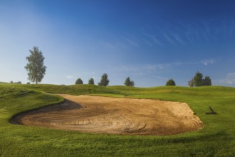 Summer golf course in the morning mist