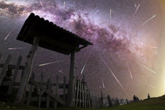 A view of a Meteor Shower and the purple Milky Way with wooden entrance door with a roof and fence