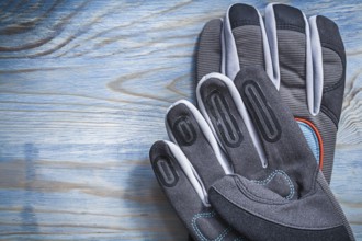 Pair of safety gloves on wooden board gardening concept