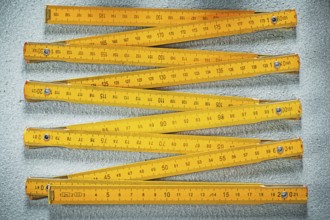Wooden meter on concrete surface construction concept