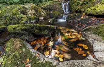 Cascade falls over mossy rocks in the vosges mountains