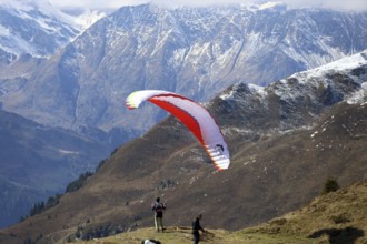 A paraglider takes off in the hiking paradise and holiday region of South Tyrol / Alto Adige on the