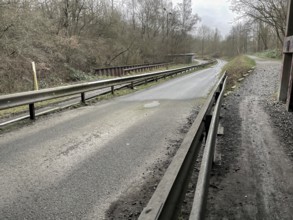 Unused industrial road in poor condition in the rain