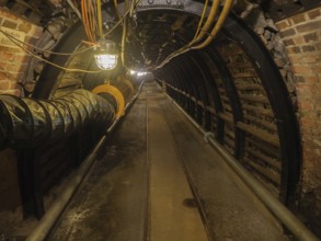 Dark industrial tunnel with brick walls and visible lighting, Bochum, North Rhine-Westphalia,