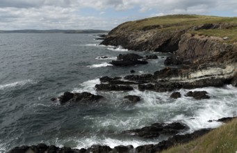 Rocky coastal area with windy waves crashing on the rocks. Atlantic Ocean. Baltimore beacon area