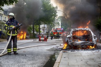 Fire brigade extinguishes burning cars on the Elbchaussee in Hamburg after the riots at the G20