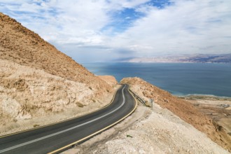 Gorgeous paved road along the seashore. The most salty sea on earth - Dead Sea. The Judean Desert