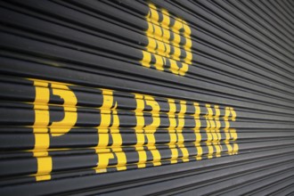 Steel roller garage door with the inscription No Parking