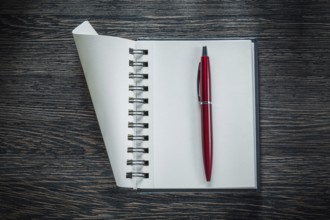 Spiral blank notebook ballpoint pen on vintage wooden board
