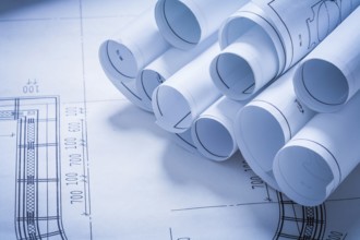 Stack of construction plans building and architecture concept
