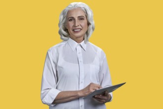 Smiling mature business woman holding pc tablet and looking at camera. Beautiful elderly woman with