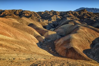 Zabriskie Point, sunrise, sun, golden path raod composed of sediments from Furnace Creek Lake,