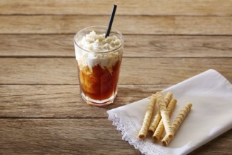 Coffee smoothie with wafers on vintage wood table