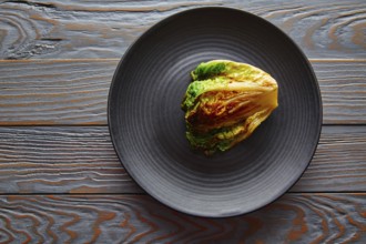 Endive little Lettuce grilled with vinaigrette sauce on black plate