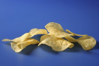 Potato fried chips still over blue background