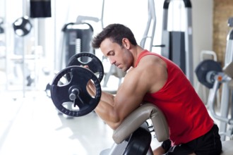 Man with weight training equipment on sport gym club