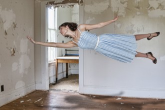 Beautiful young woman floating in the air