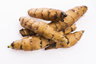 Raw Whole Jerusalem artichokes on a white background