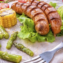 Grilled krakauer sausage with boiled corn and green salad