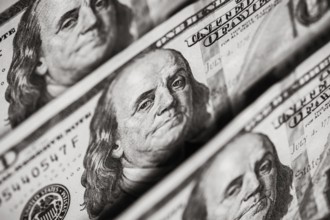 Hundred dollars bills standing in a row. Selective focus
