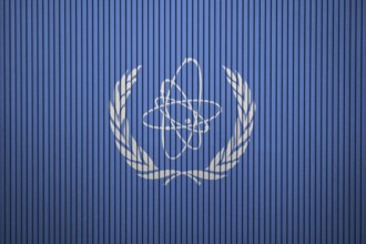IAEA Flag painted on the cracked grunge concrete wall, International Atomic Energy Agency