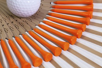 Typical Japanese hand fan made of bamboo and golf equipments