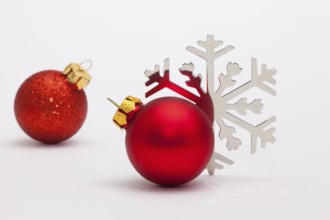 Red Christmas decoration and snowflake on the white table