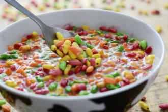 Prepared breakfast with colorful puffed rice with spilled rice in the background