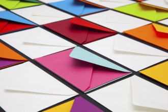 Composition with white and colored envelopes on the table. The photo suitable for various holidays