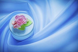 Round gift box on blue fabric background holidays concept