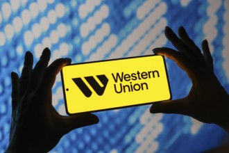 In this photo illustration, the Western Union logo is displayed on a smartphone screen