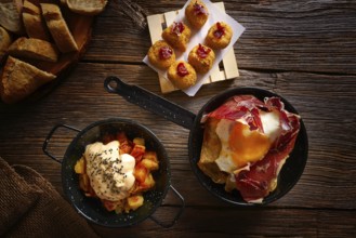 Tapas of Spain broken eggs Croquettes and Bravas potatoes