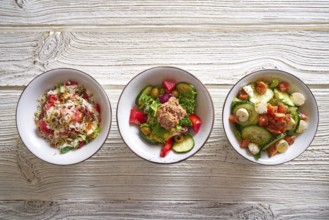 3 salad mix bowls healthy food on white wood table