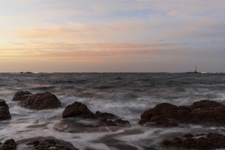 Long view of the Mangiabarche Lighthouse at sunrise on Sardinia
